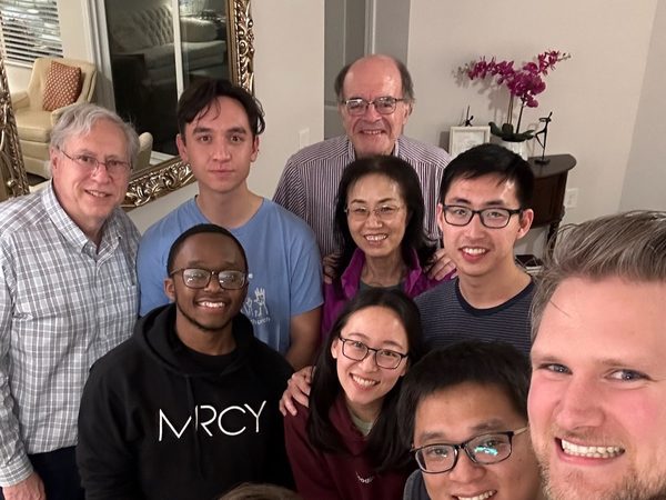 A group of believers smiling together after a gathering