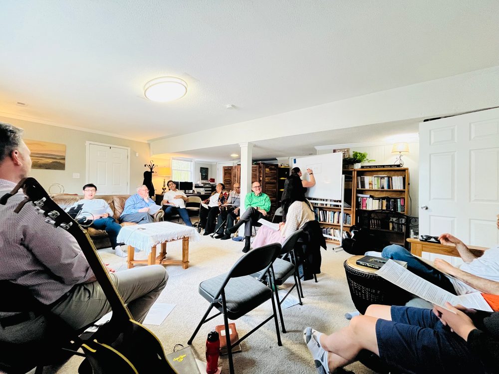 A home gathering of the church meeting together around the Word